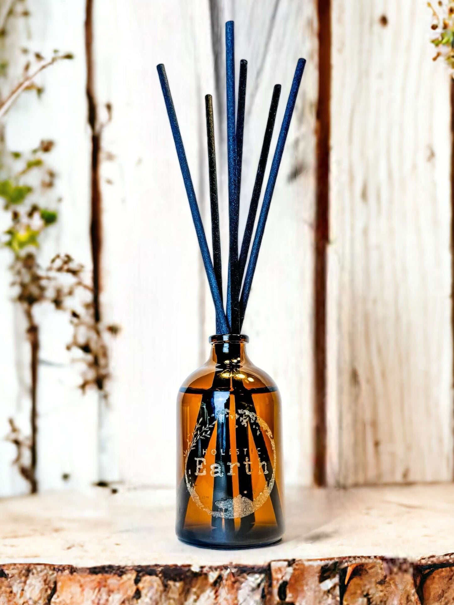 A small Holistic Earth reed diffuser in a house setting.