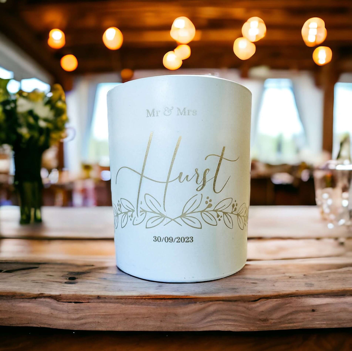 An example personalised wedding candle featuring our wreath design.