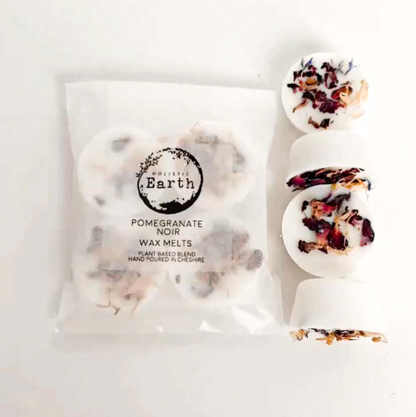 A pack of 4 wax melts in Holistic Earth packaging.